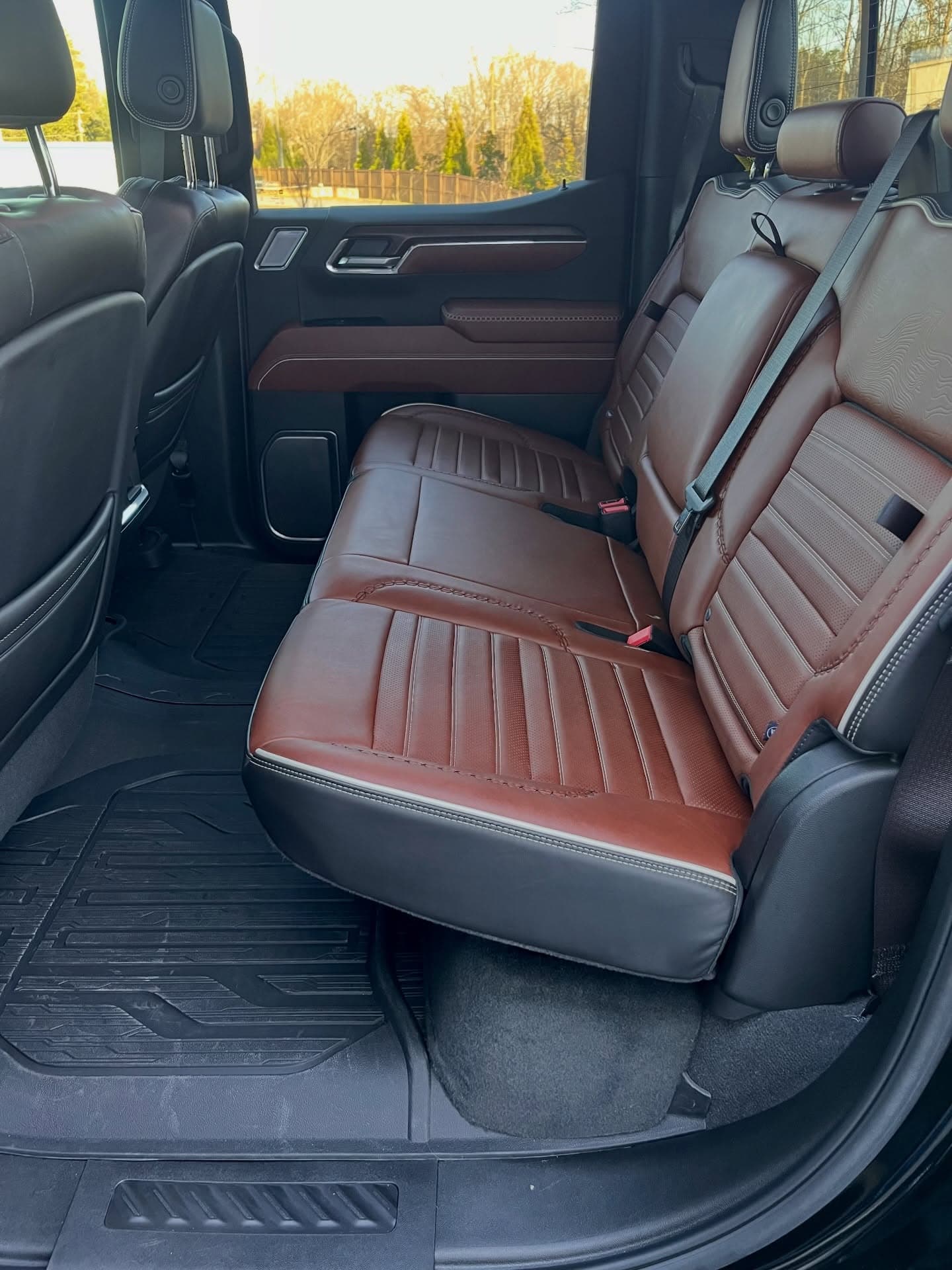 Clean cognac leather rear bench seat after an Adams Package interior detail, Cumming GA