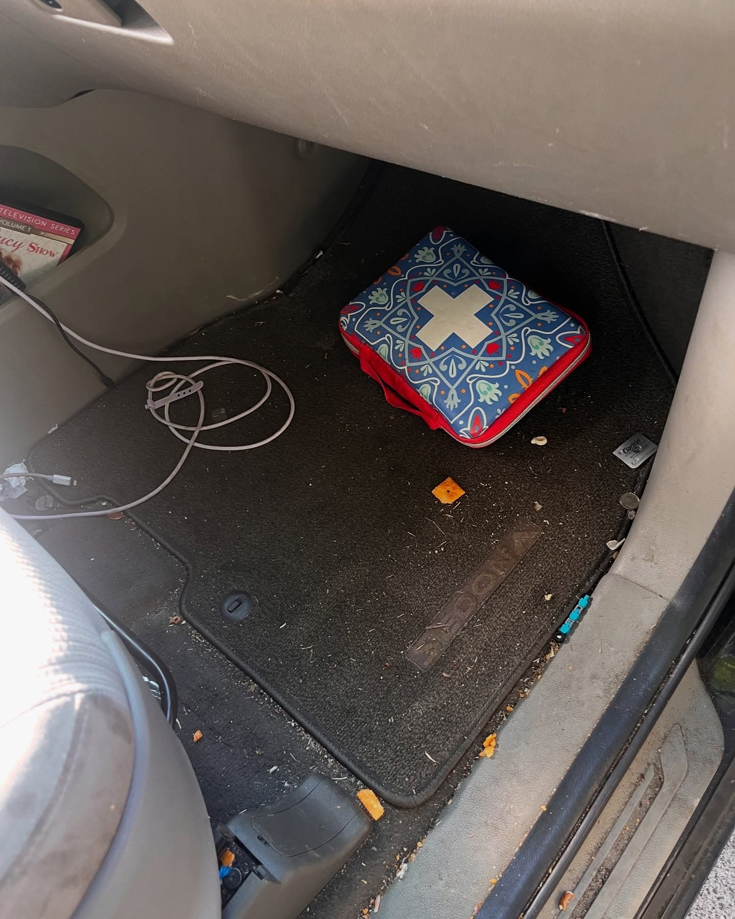 Cluttered, crumb-covered passenger footwell before a full detail, Cumming GA