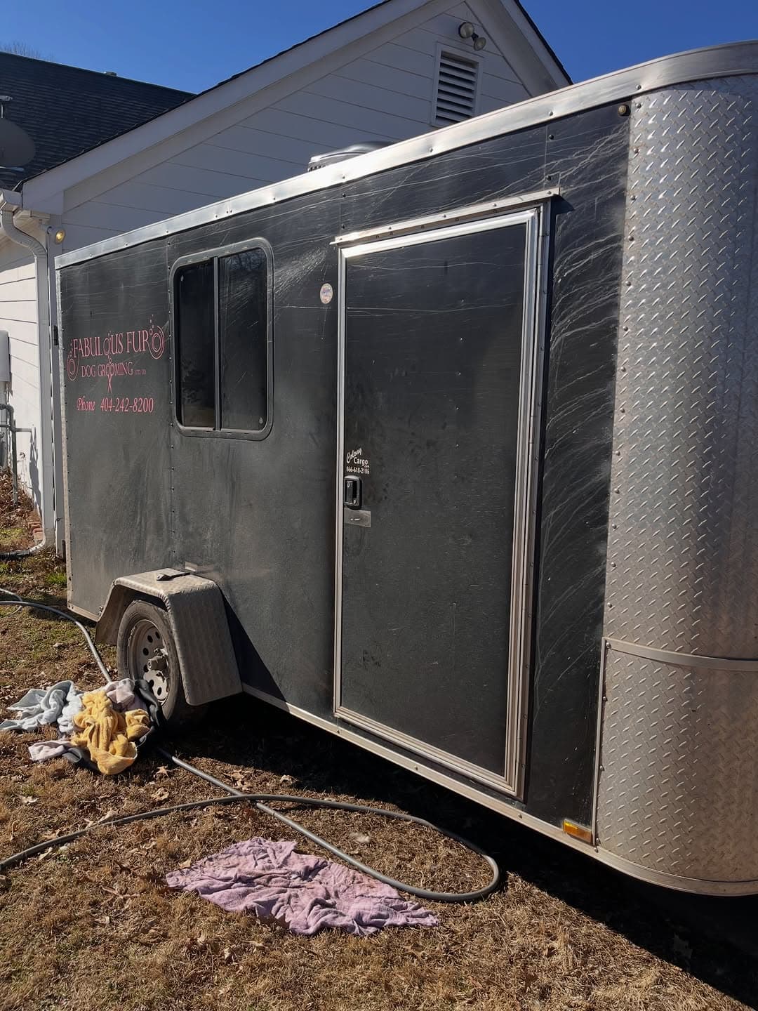 Dull, swirled black panel on the Fabulous Fur grooming trailer before 2-step paint correction, Forsyth County GA